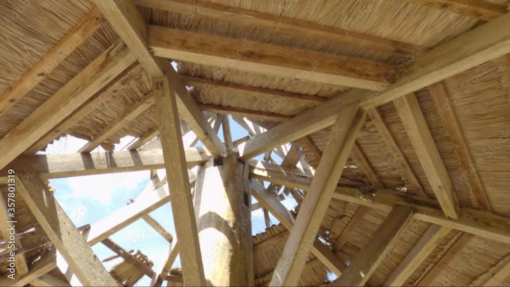 Sun flare passes through a wooden roof. Look up view. Sun flare passes through a wooden roof. Look up view.