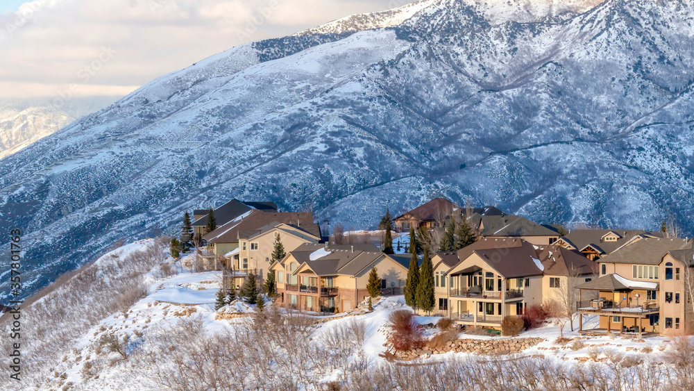 Panorama crop Homes nestled amid pristine Wasatch Mountain views blanketed with snow in winter