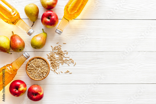 Apple and pear cider on white wooden background top view copy space photo