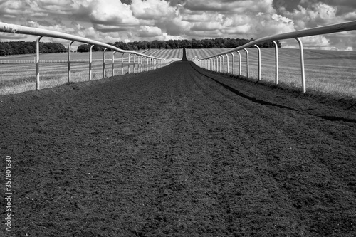 Fototapet Monochrome image of a horse gallop track in a large open space in rural Britain