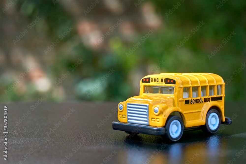 Yellow school bus toy model. Back to school concept. Image with selective focus and copy space