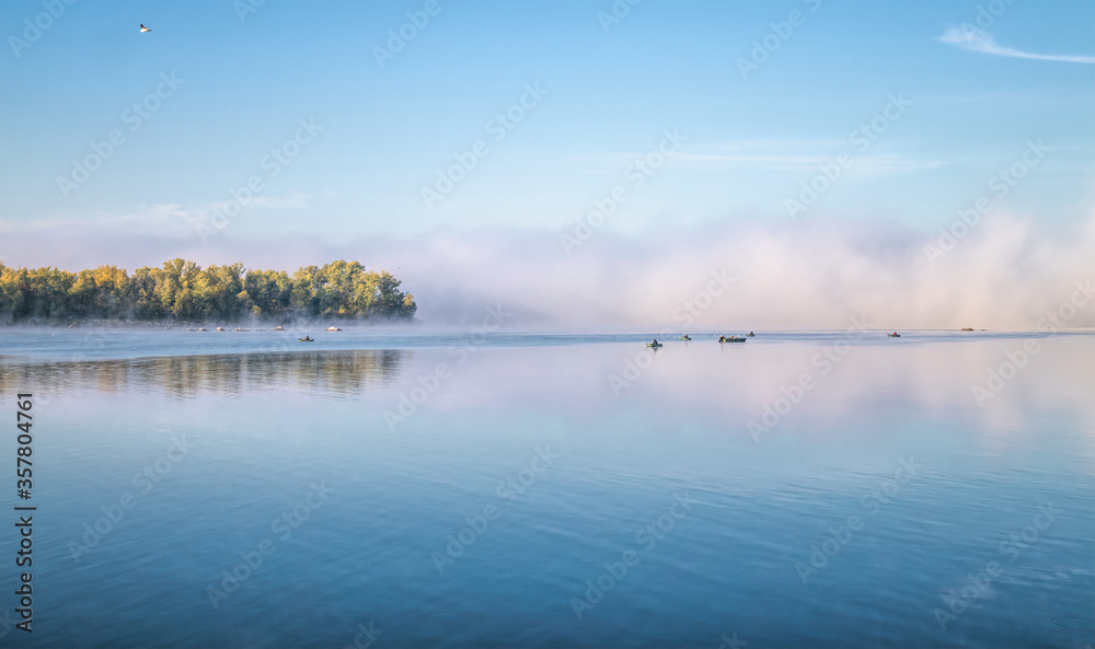 Fresh autumn foggy morning and fishing on the lake