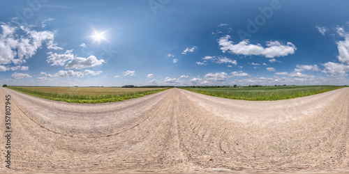 Full spherical seamless panorama 360 degrees angle view on no traffic white sand gravel road among fields with clear sky with beautiful clouds in equirectangular projection  VR AR content