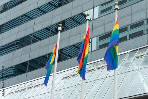 Three flags over LGBT building, minorities, protection and equality
