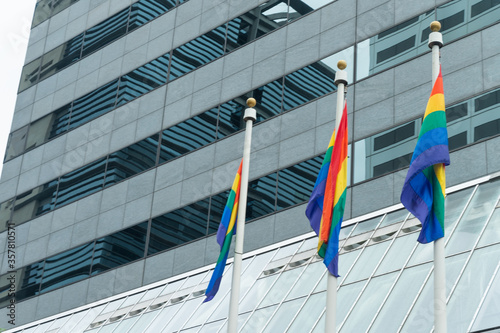 Three flags over LGBT building, minorities, protection and equality