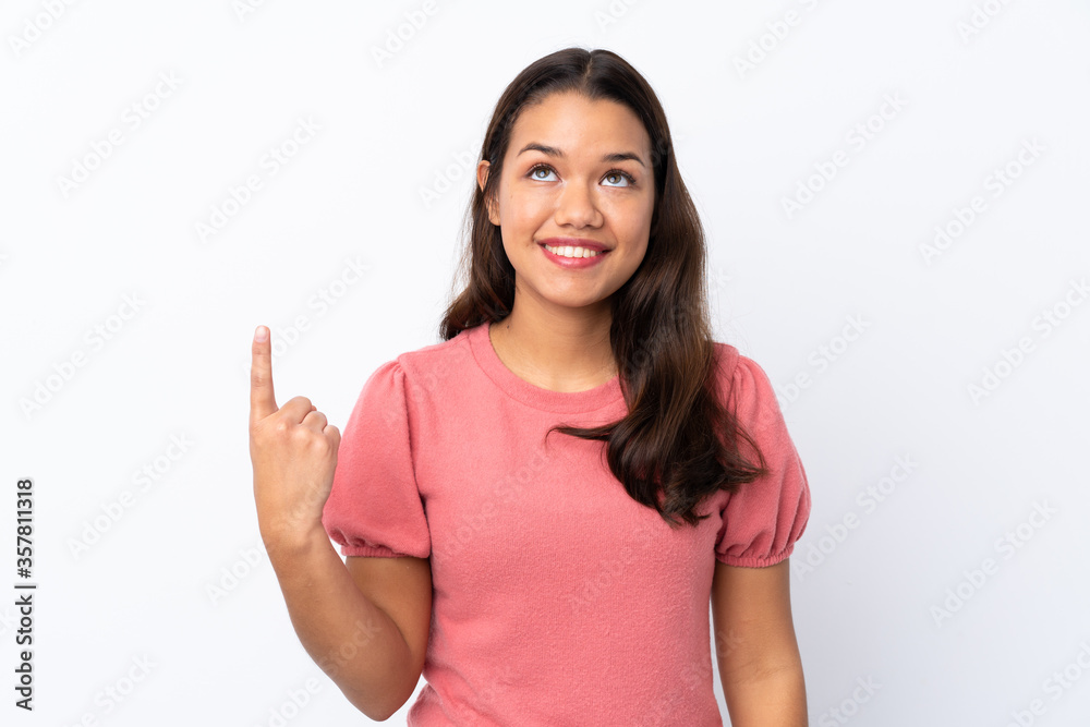 Young Colombian girl over isolated white background pointing up and surprised Young Colombian girl over isolated white background pointing up and surprised