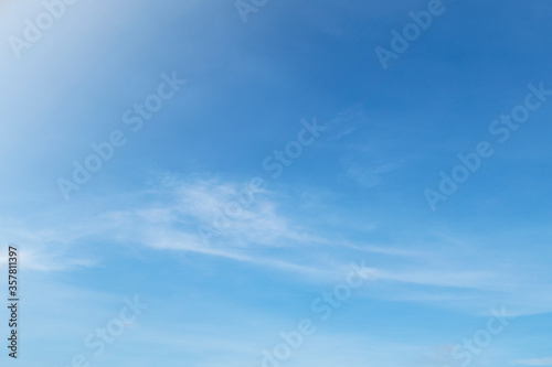 Beautiful sunny blue sky background with white clouds © BuaLily