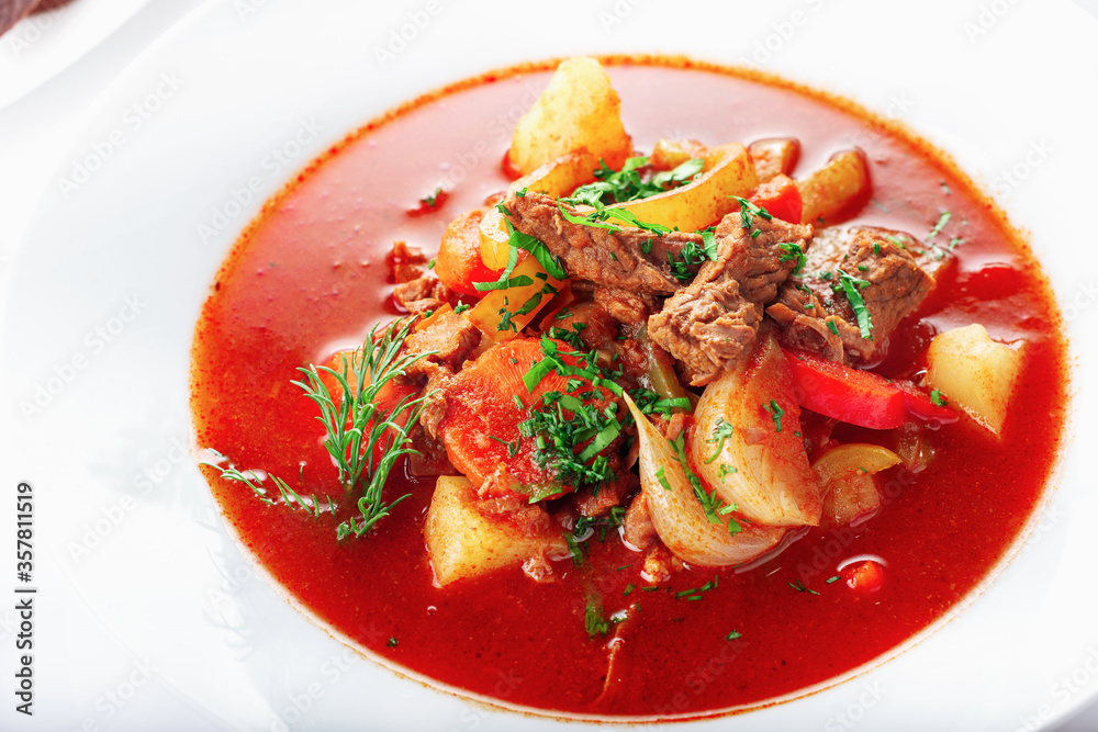 Hot beef hungarian goulash soup with paprika, beef, potatoes, carrots, onion, pepper and herbs. Hot beef hungarian goulash soup with paprika, beef, potatoes, carrots, onion, pepper and herbs.