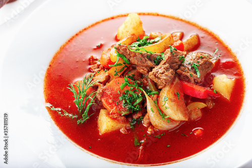 Hot beef hungarian  goulash soup with paprika, beef, potatoes, carrots, onion, pepper and herbs.