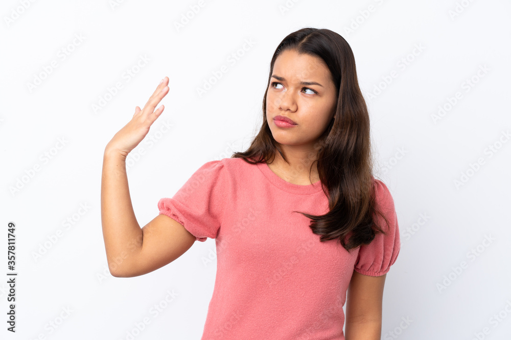 Young Colombian girl over isolated white background with tired and sick expression Young Colombian girl over isolated white background with tired and sick expression