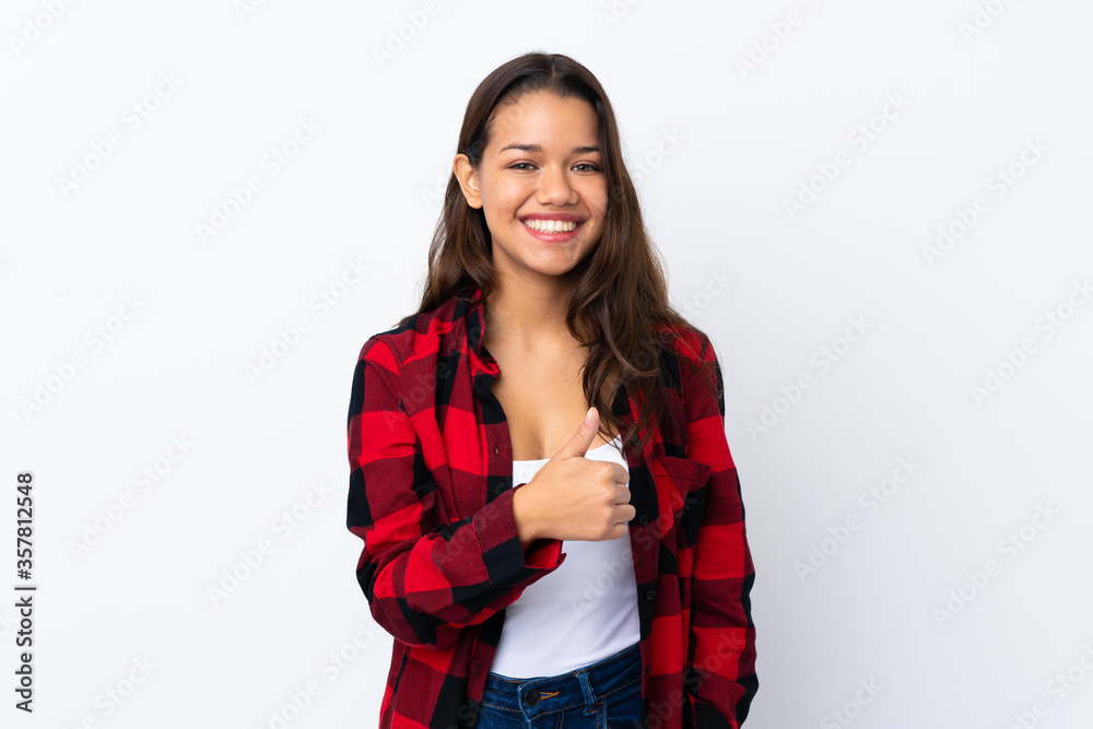 Young Colombian girl over isolated white background giving a thumbs up gesture Young Colombian girl over isolated white background giving a thumbs up gesture