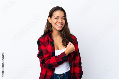 Young Colombian girl over isolated white background celebrating a victory