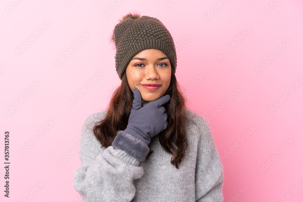 Young Colombian girl with winter hat over isolated pink wall laughing Young Colombian girl with winter hat over isolated pink wall laughing