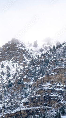 Vertical frame Provo Canyon with rugged steep slope with frozen water and snow in winter