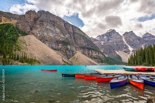 Corlorful canoes on Moraine lakel near Lake Louise village in Banff National Park, Alberta, Rocky Mountains, Canada photo