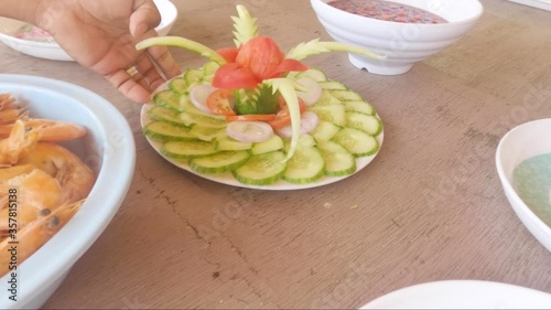 Presenting of vegetable dish made up of cucumber and tomato. photo