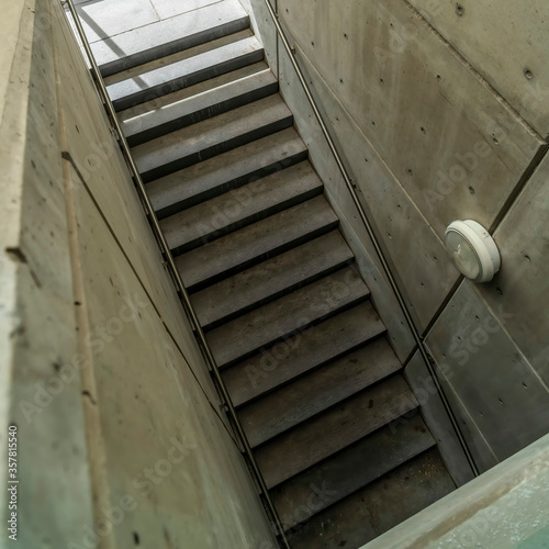 Square Looking down on staircase with metal handrails inside of commercial building