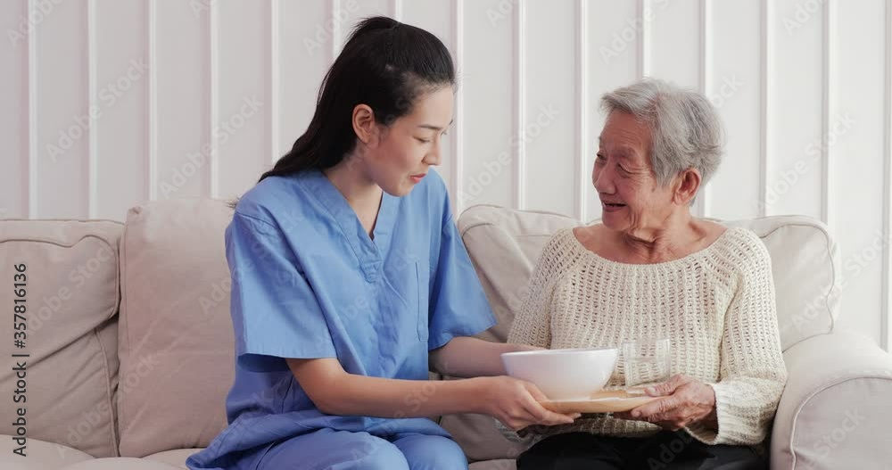 Asian elderly woman being fed by a nurse by volunteer with happy emotion. Female volunteer assist to senior woman with smiling.
Asian elderly woman being fed by a nurse by volunteer with happy emotion. Female volunteer assist to senior woman with smiling.