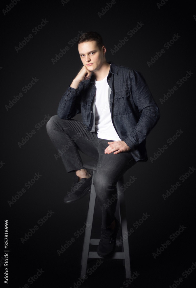 Portrait of an attractive man in the studio on a black background. Portrait of an attractive man in the studio on a black background.