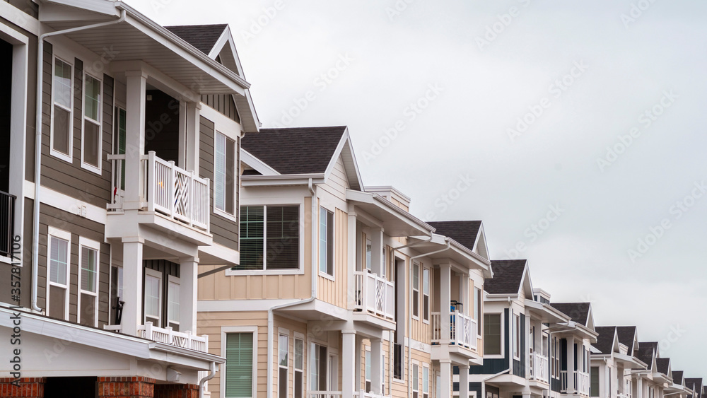 Panorama Row of modern upmarket duplex apartments day light Panorama Row of modern upmarket duplex apartments day light