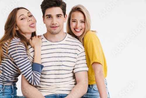Image of pleased man and cheerful women hugging and posing on camera