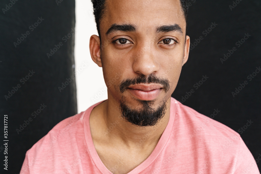 Photo of handsome african american man posing and looking at camera