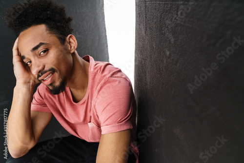 Photo of joyful african american man smiling and looking at camera © Drobot Dean