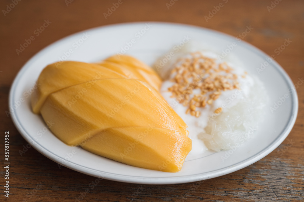 Mango sticky rice topped with dehusk green bean and sweet coconut milk