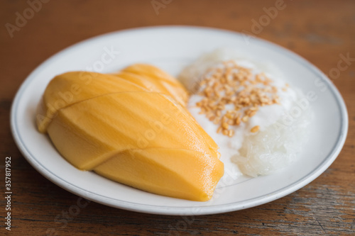 Mango sticky rice topped with dehusk green bean and sweet coconut milk