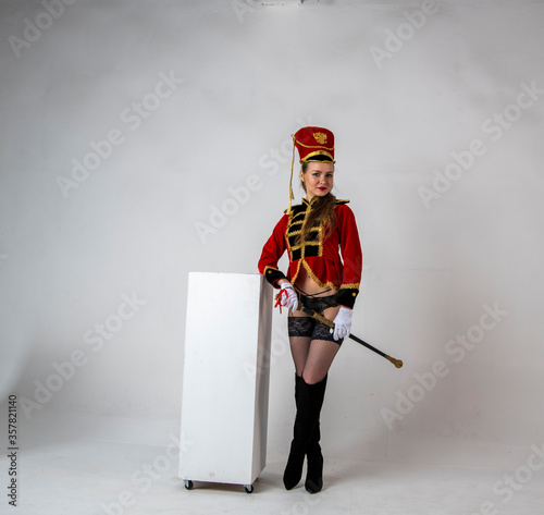 Canvastavla beautiful girl in a red hussar costume with a sword