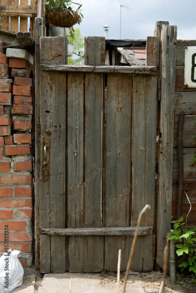 Background old wooden door, brick wall and trash bags. Background old wooden door, brick wall and trash bags.
