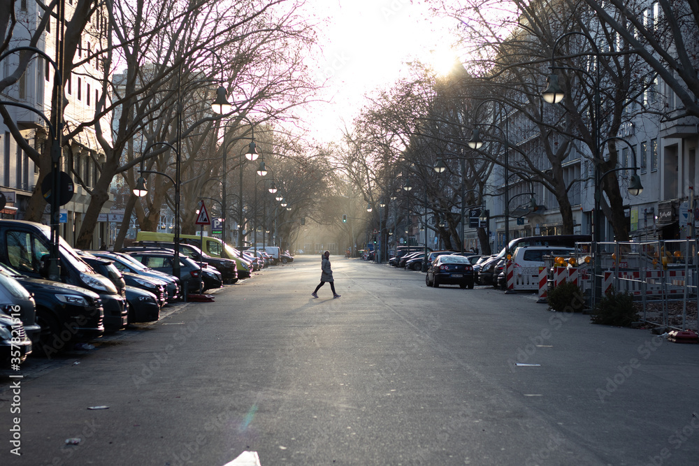 Silhouette Of Man Crossing empty Street At Sunset