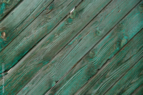 Background of old painted wooden planks laid out diagonally.