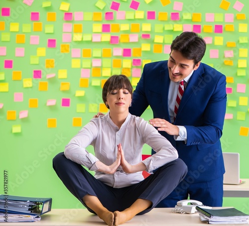 Fototapeta Naklejka Na Ścianę i Meble -  Man and woman in the office with many conflicting priorities in
