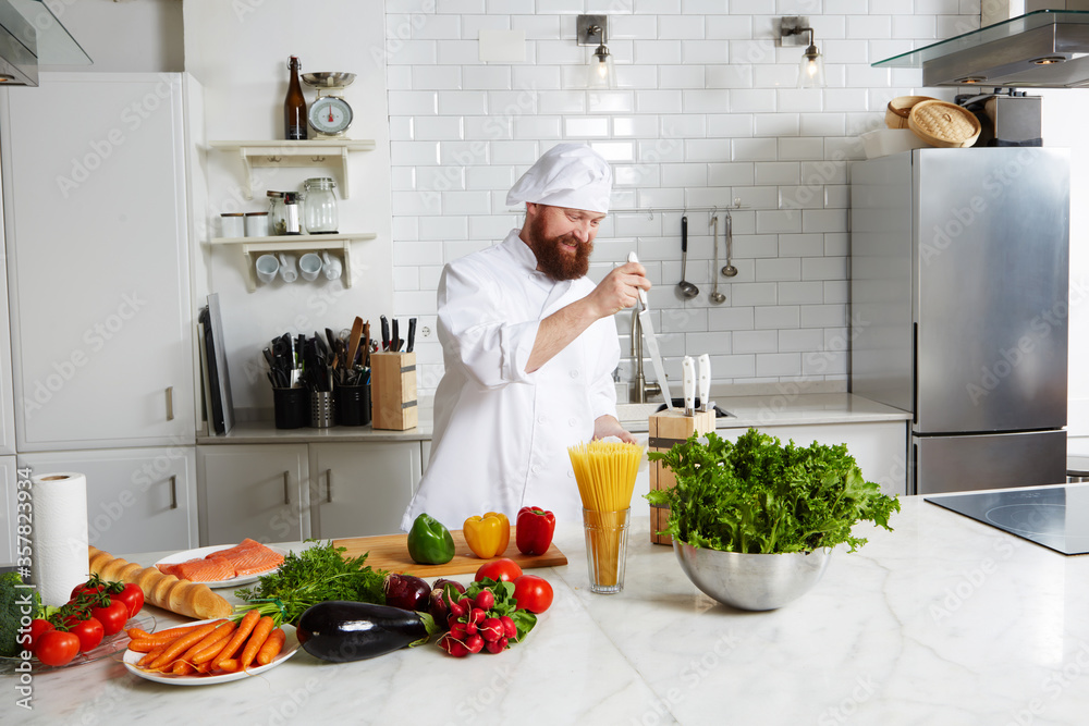 Portrait of mature chef in uniform prepare his kitchen Portrait of mature chef in uniform prepare his kitchen