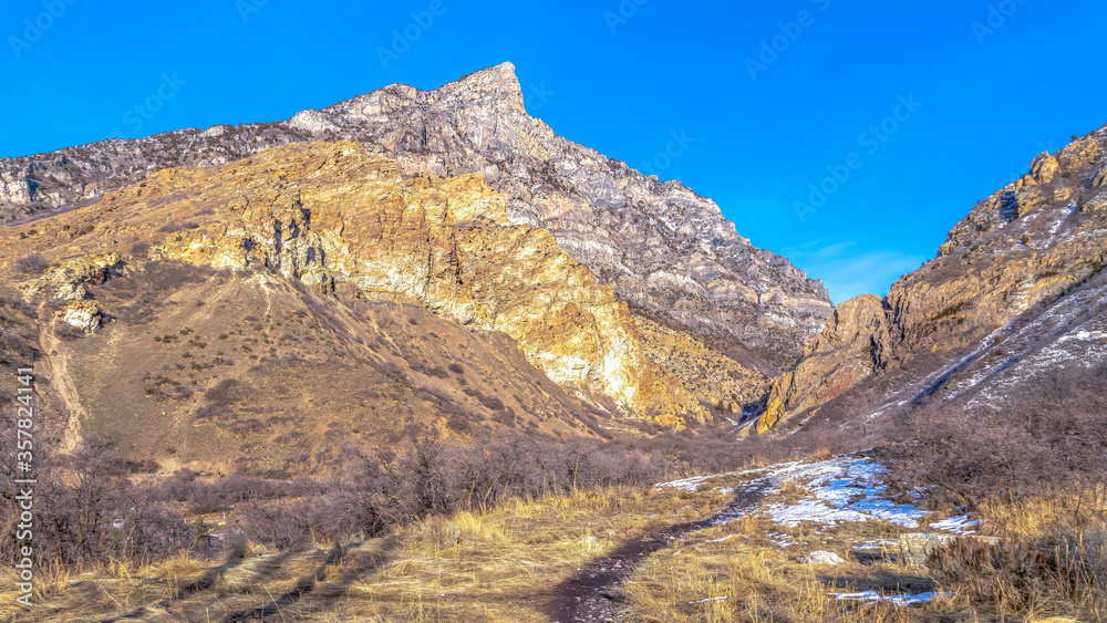 Panorama Trail on a grassy terrain with view of a rocky mountain in Provo Canyon Utah