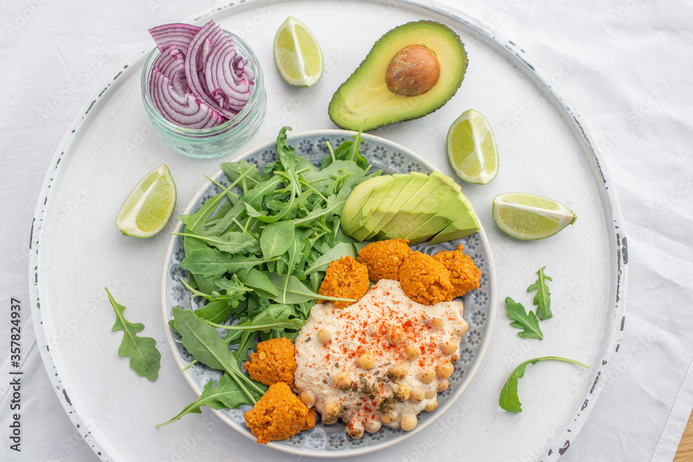 Vegan lunch bowl with quinoa, hummus, chickpeas, avocado, 