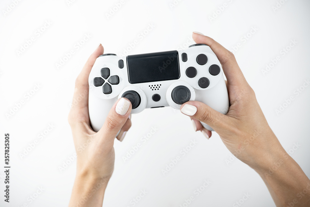 woman's hands holding joystick , video gaming, leisure and timespending on isolated while background woman's hands holding joystick , video gaming, leisure and timespending on isolated while background