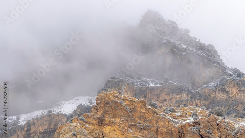 Panorama Misty clouds over the rugged peak of rocky mountain in Provo Canyon Utah