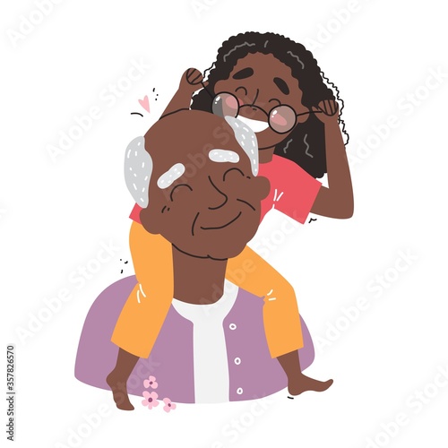 an elderly black african american man is having fun with his granddaughter