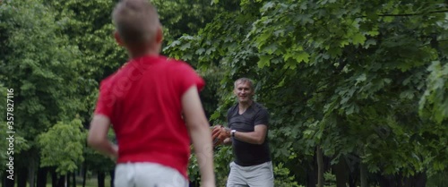 MED Father and son playing baseball catch in the park on a rainy day. Family time spent together. Shot with 2x Anamorphic lens