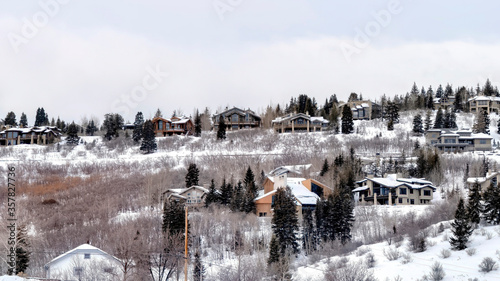 Panorama Neighborhood homes sitting on snow covered mountain slope in Park City Utah