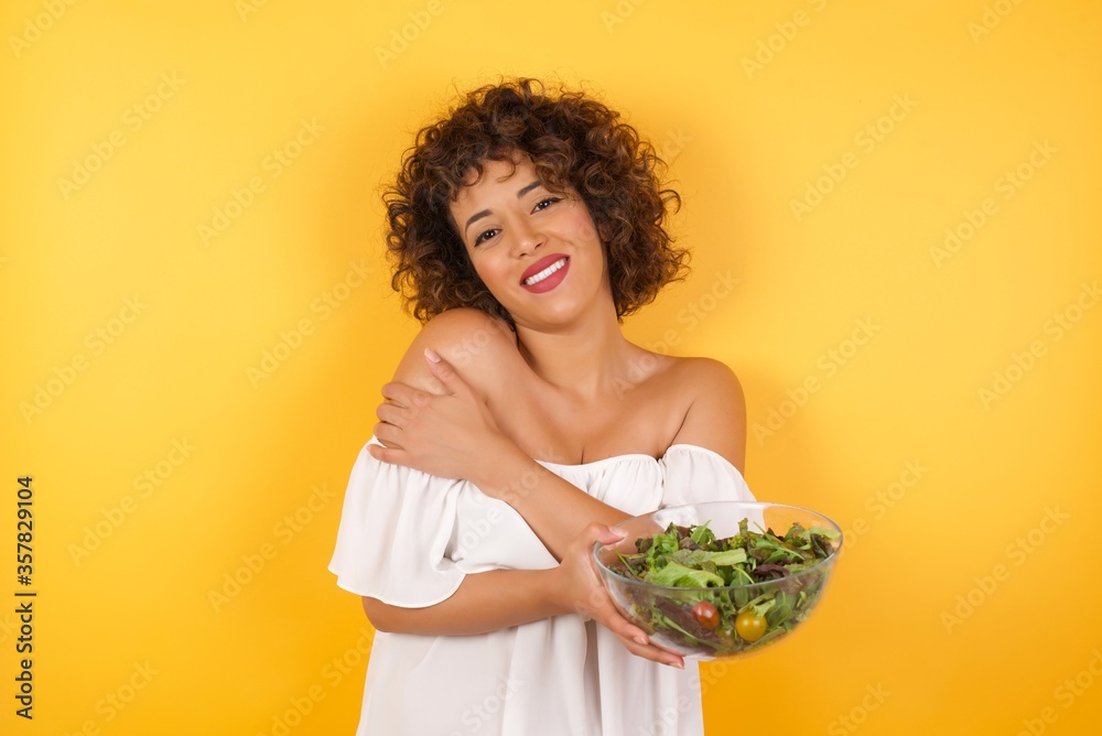 People, lifestyle, youth and happiness concept. Shy pretty girl feeling happy after boy who she likes invited her out on date. People, lifestyle, youth and happiness concept. Shy pretty girl feeling happy after boy who she likes invited her out on date.