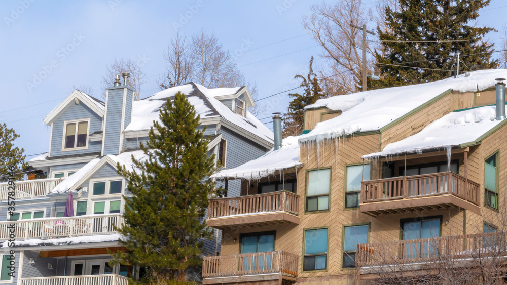 Panorama Mountain homes in Park City Utah with snow and icicles on roofs in winter