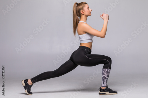 Young woman doing fitness exercises on white background