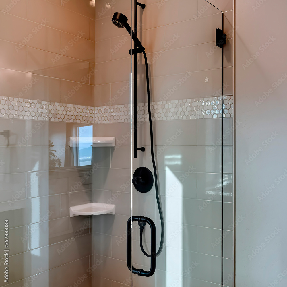 Square Shower stall with frameless glass enclosure and hinged door