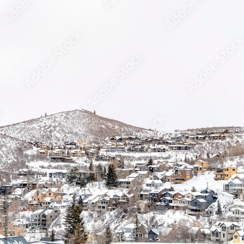 Square Park City Utah mountainscape with homes on a snowy neighborhood in winter