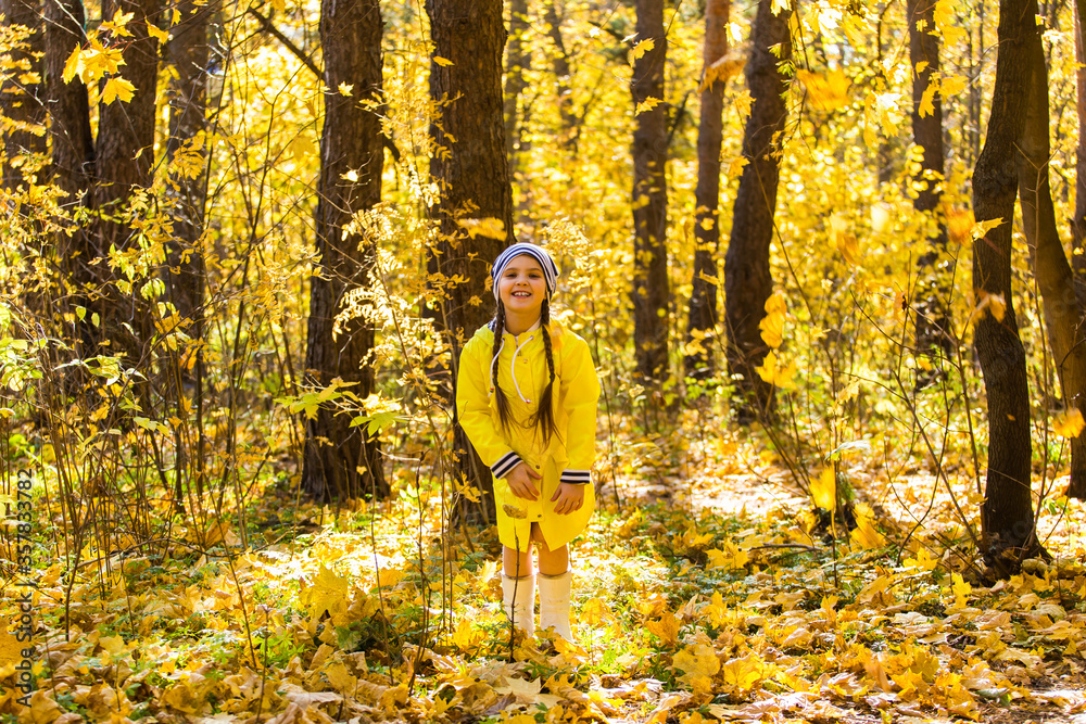 Portrait of a little girl on a background of orange and yellow leaves in an autumnal sunny day. Little puppy jack russell terrier. Pet and child concept. Friendship. Portrait of a little girl on a background of orange and yellow leaves in an autumnal sunny day. Little puppy jack russell terrier. Pet and child concept. Friendship.