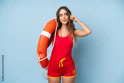 Young woman over isolated background with lifeguard equipment and having doubts with confuse face expression