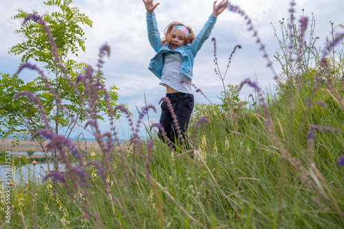Summer small girl happy in flower field © Daria